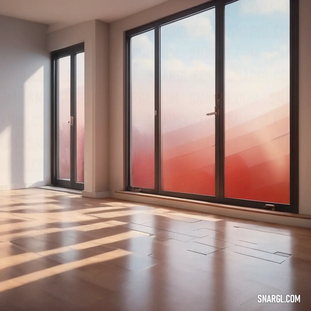 A bright room featuring a generously sized window allowing natural light to pour in, accentuated by a wooden floor and a striking red wall that offers a refreshing view of the sky.