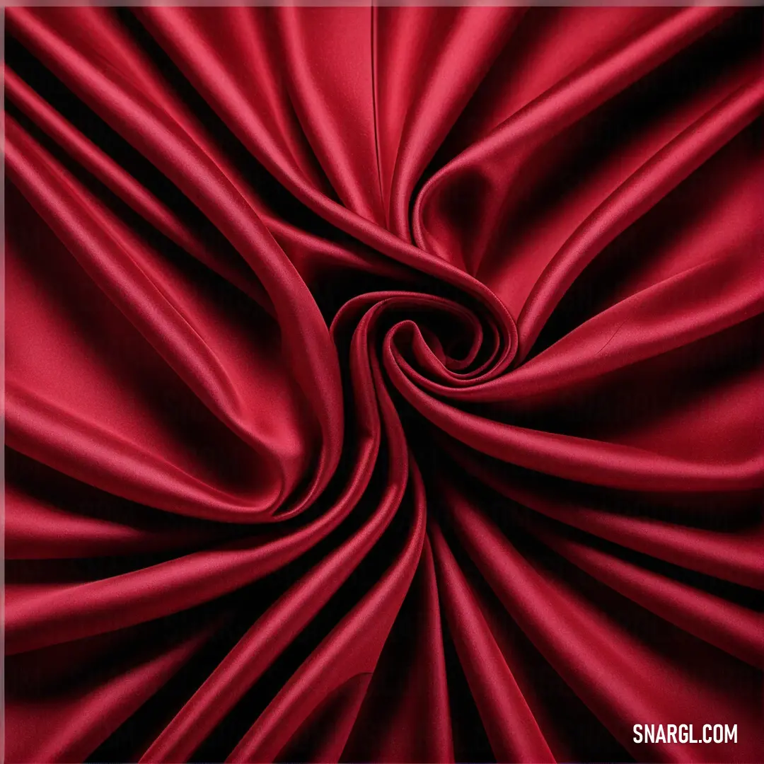Red fabric with a spiral design on it's side and a black background with a white border