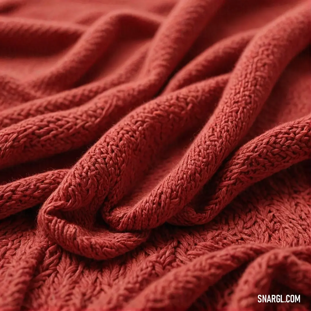 A beautifully layered composition showcases a soft red blanket draped gracefully over a bed, topped with another matching blanket, inviting viewers into a warm and cozy embrace perfect for restful nights and peaceful slumbers.