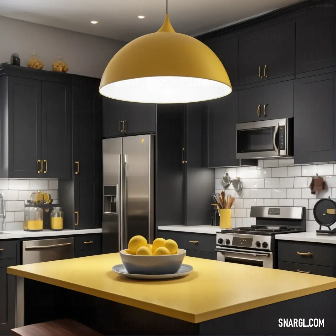 Bowl of lemons on a kitchen counter top with a yellow light hanging over it and a stainless steel refrigerator