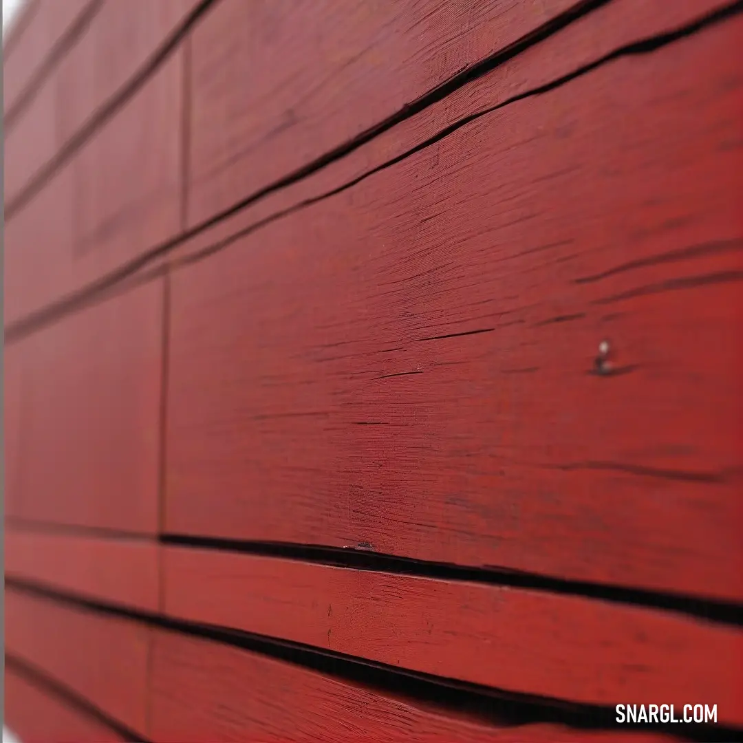 A detailed close-up of a vibrant red wooden wall set against a simple white backdrop, emphasizing the intricate textures and colors. The composition showcases the beauty of craftsmanship and natural materials.