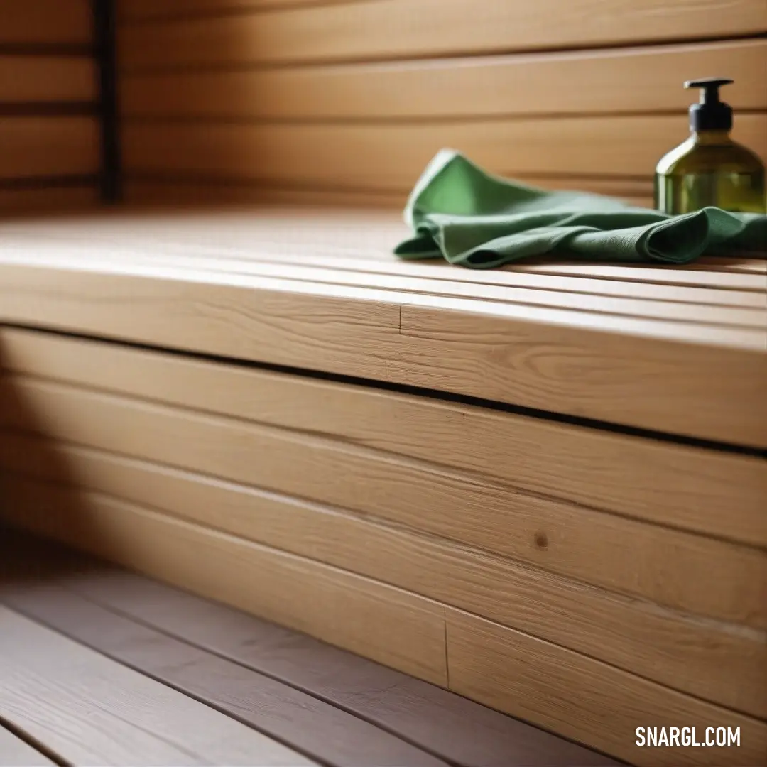 A bottle of soap sits atop a wooden bench, accompanied by a soft towel. The warm wood tones and gentle textures of the soap and towel create a calm, spa-like ambiance. The color scheme features soft pastel hues such as RGB 231,201,210, adding to the peace