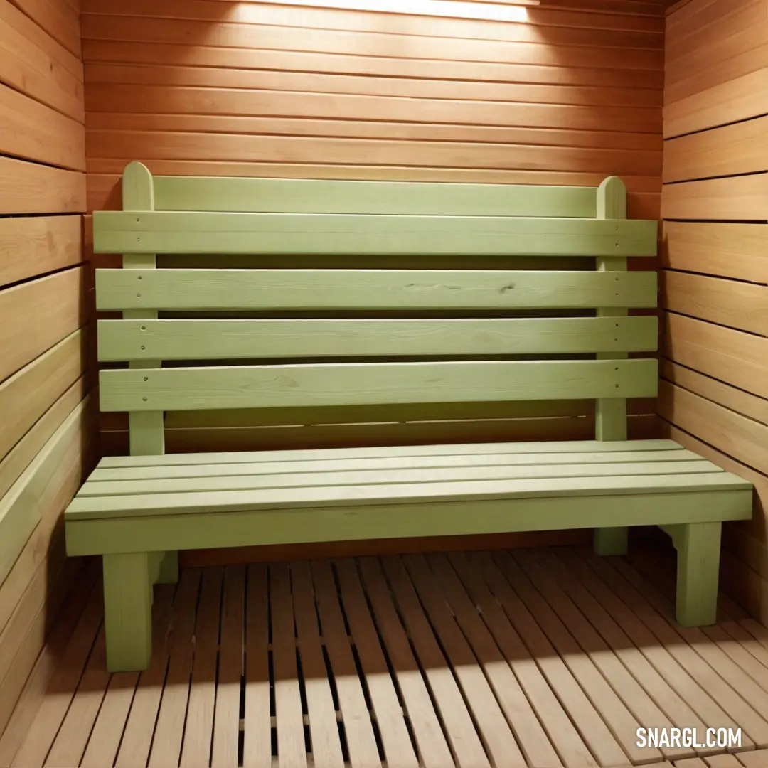 A green bench is nestled in a wooden sauna, surrounded by rich wood slats that line the walls and floor. The natural wood tones and the serene green of the bench create a relaxing, earthy atmosphere, accented by the soft CMYK 2,23,4,0 color blend.