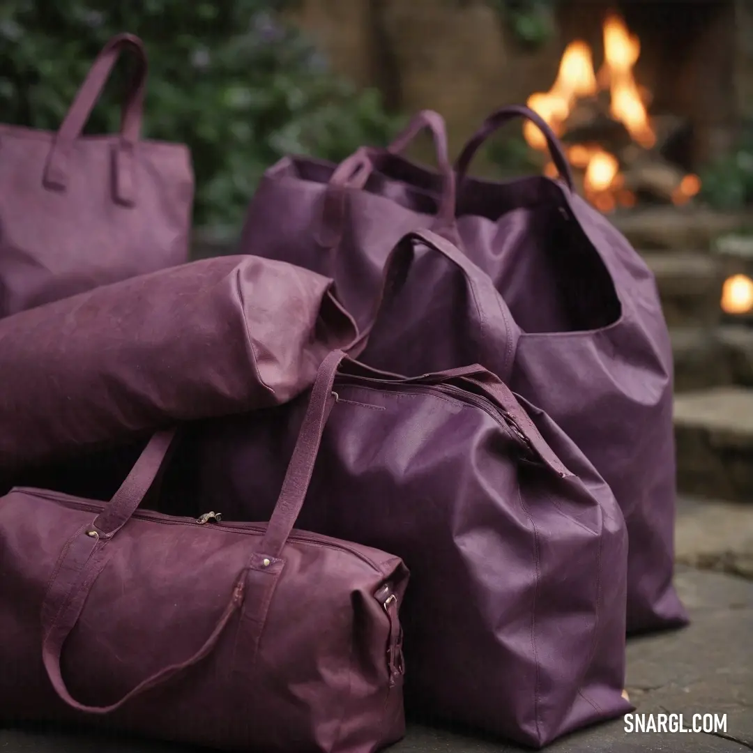 A pair of leather bags resting on a stone floor near a glowing fireplace, with soft candlelight illuminating the warm tones of the room. The cozy scene evokes a sense of tranquility and warmth, perfect for a relaxing evening at home.