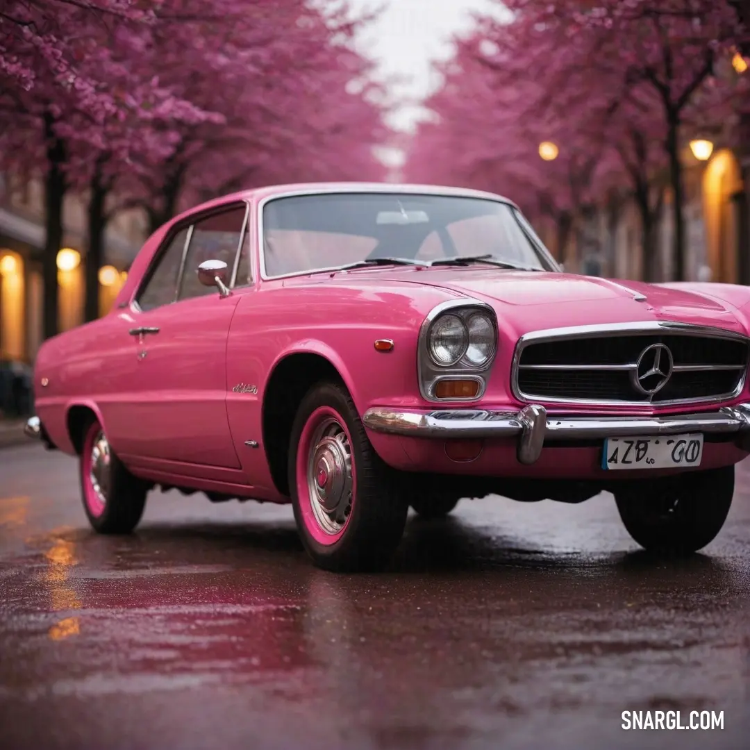 A charming pink car is parked serenely on a tree-lined street, with the vibrant PANTONE 206 color becoming a delightful focal point against a picturesque natural backdrop.