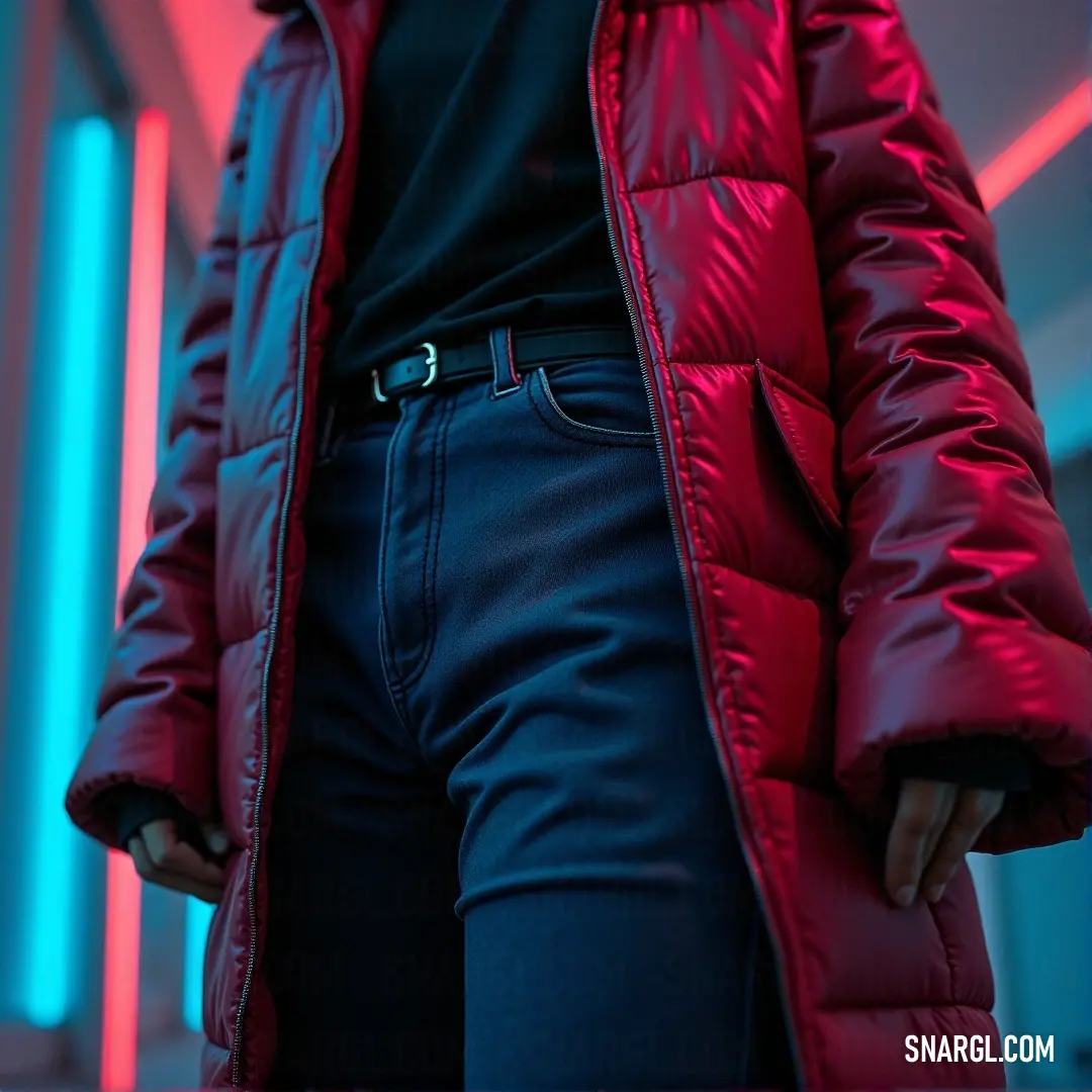 A fashionable woman clad in a bold red coat presents an impressive look, standing in a dimly lit room adorned with radiant neon lights, her black shirt adding a touch of sophistication to the striking color palette.