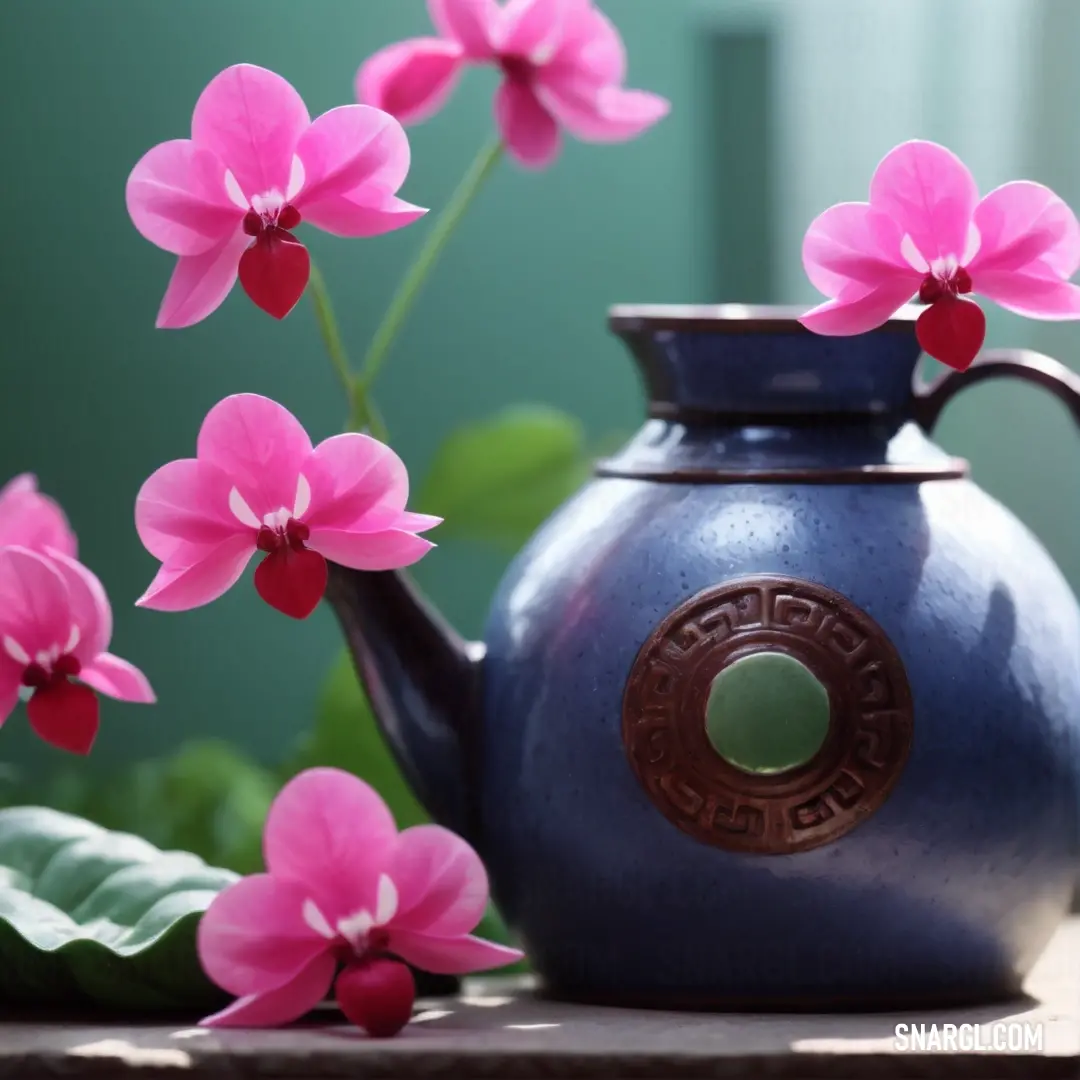 A picturesque blue teapot adorned with pink flowers sits gracefully on a table, complemented by a lush green plant and a softly lit window, creating a serene atmosphere that encourages relaxation and connection.