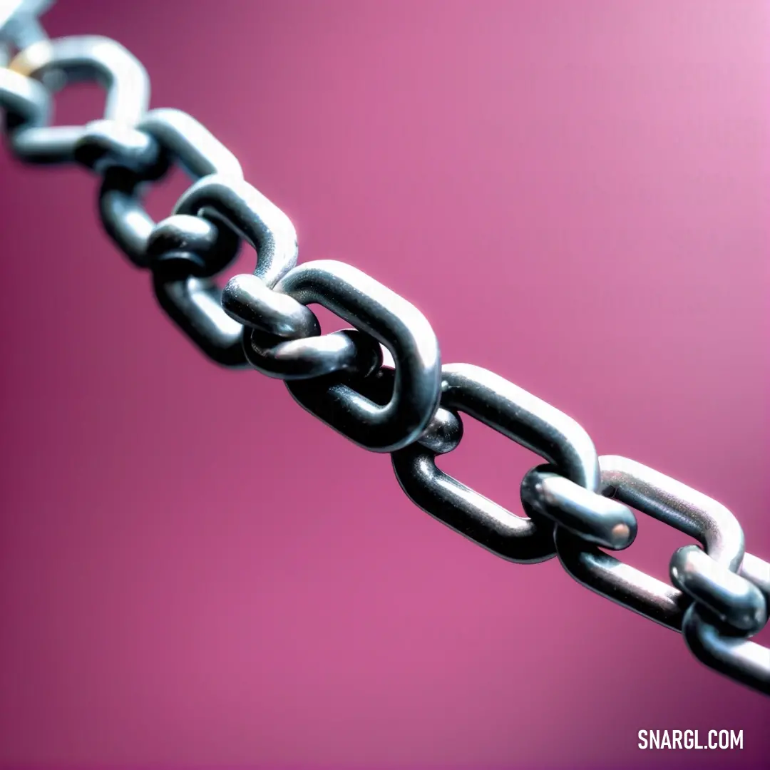 A close-up shot of a metallic chain glimmers against a soft pink background. The intricate detailing of each link adds depth and dimension, transforming an everyday object into a striking focal point.