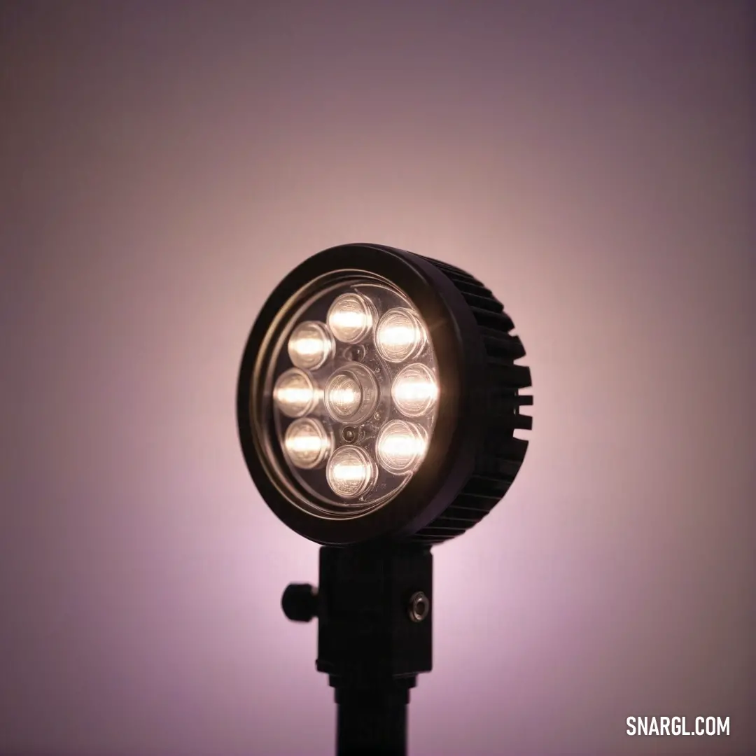 A charming close-up of a lamp atop a pole, radiating warm light against a mesmerizing purple backdrop, inviting feelings of warmth and comfort, and highlighting the beauty of illumination in serene surroundings.