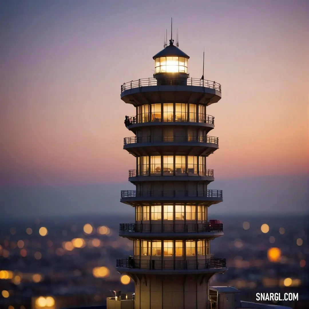 A majestic view of a tall tower topped with a glowing light, set against a scenic night sky filled with twinkling city lights. The contrast of the tower's silhouette against the vibrant backdrop creates a captivating urban scene.