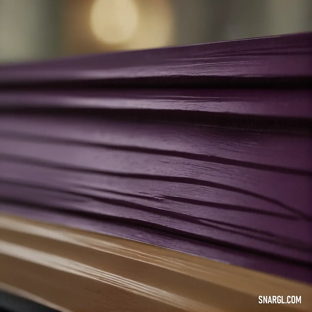 A close-up shot of a rustic purple wooden bench, its intricate details and weathered charm standing out against a blurry, calming background. The soft purple color evokes a sense of quiet, peaceful solitude.