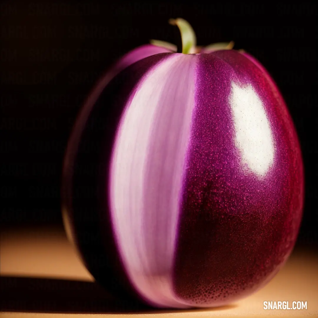 Close up of a red onion on a table top with a black background and a light reflection on the surface