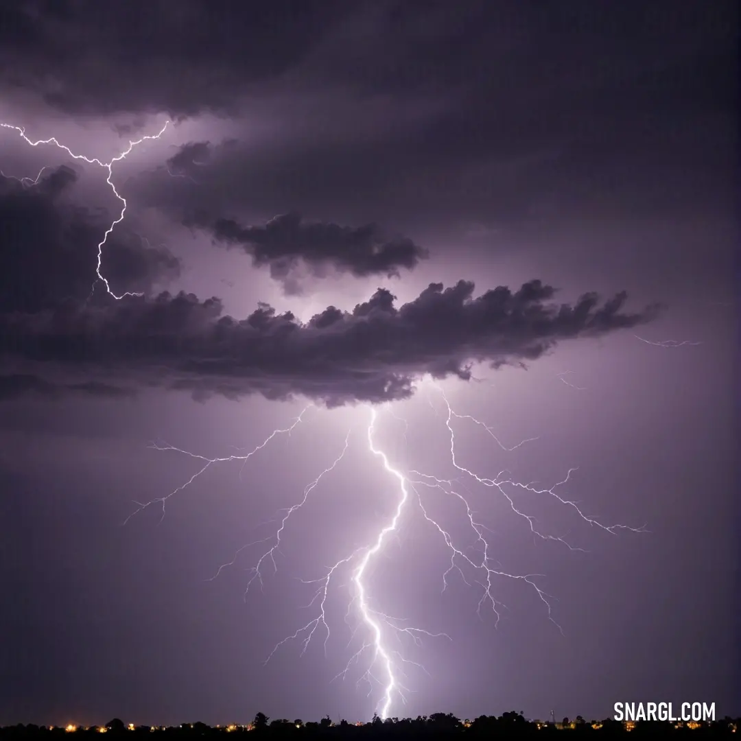 A breathtaking view of a lightning storm sweeping over a bustling city at night. Dark, ominous clouds loom overhead as brilliant bolts of lightning create a startling contrast, capturing the essence of the evening with a soft glow of city lights below.