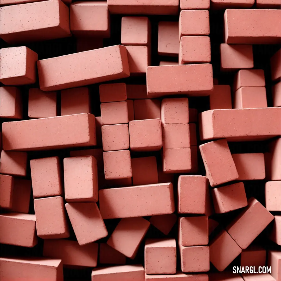 A colorful assortment of pink bricks elegantly laid side by side on a table, complemented by a vivid red background that enhances their soft hues. The arrangement creates a stunning visual narrative of color and texture.