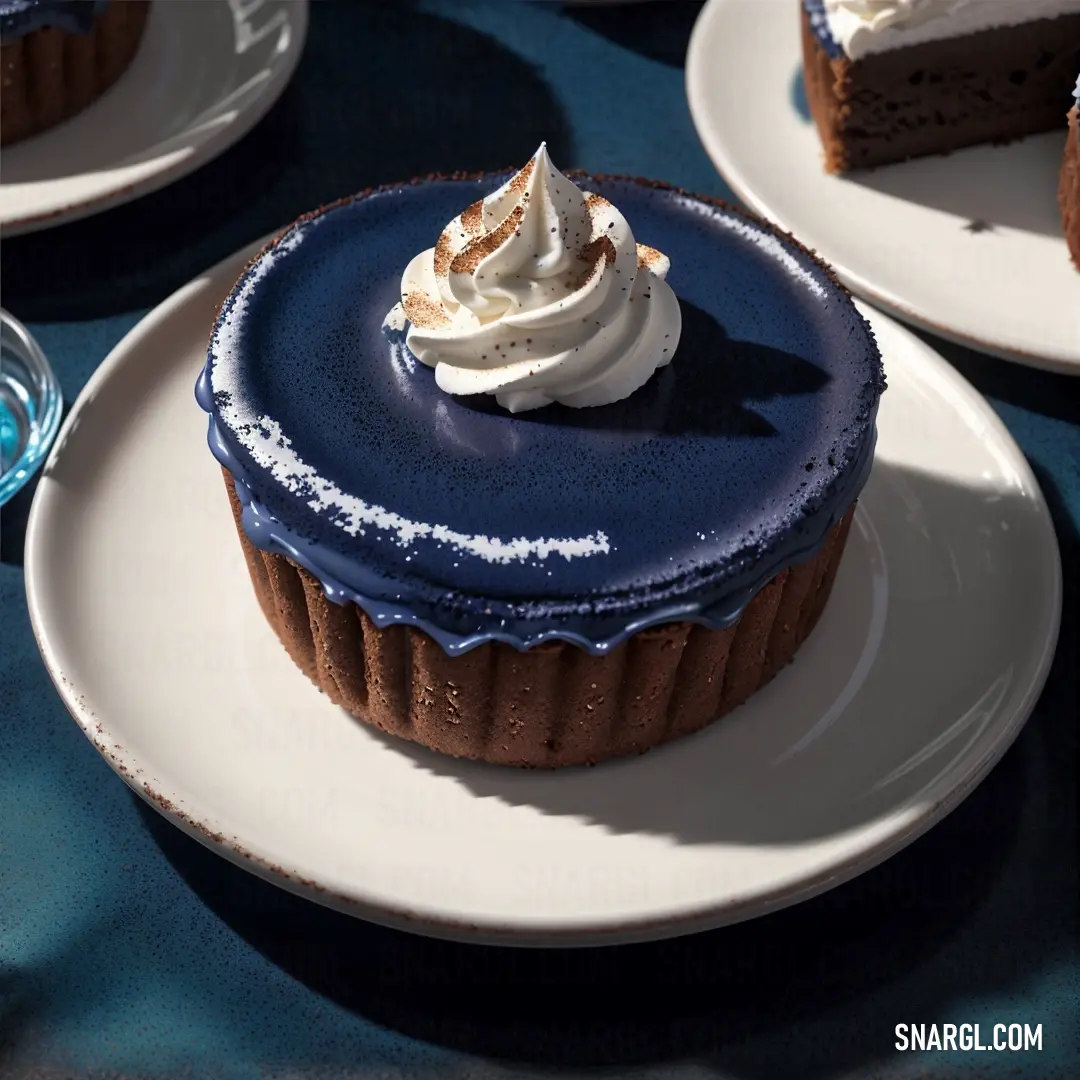 Chocolate cake with whipped cream on top of it on a plate with a blue table cloth and a glass of water. Example of #3F5173 color.