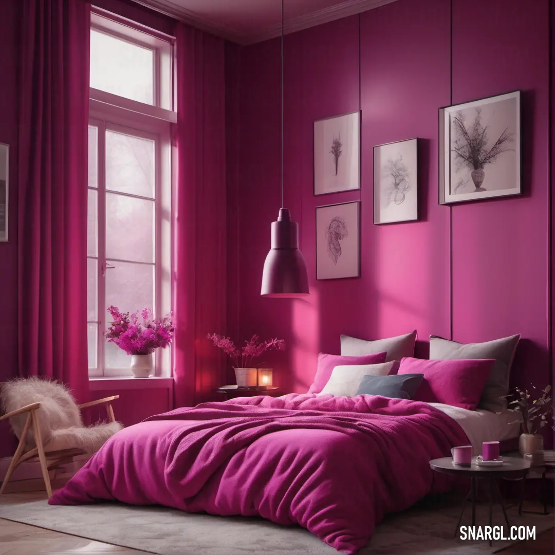 Bedroom with a pink wall and a bed with a pink comforter and pillows and a chair and a table with a vase of flowers