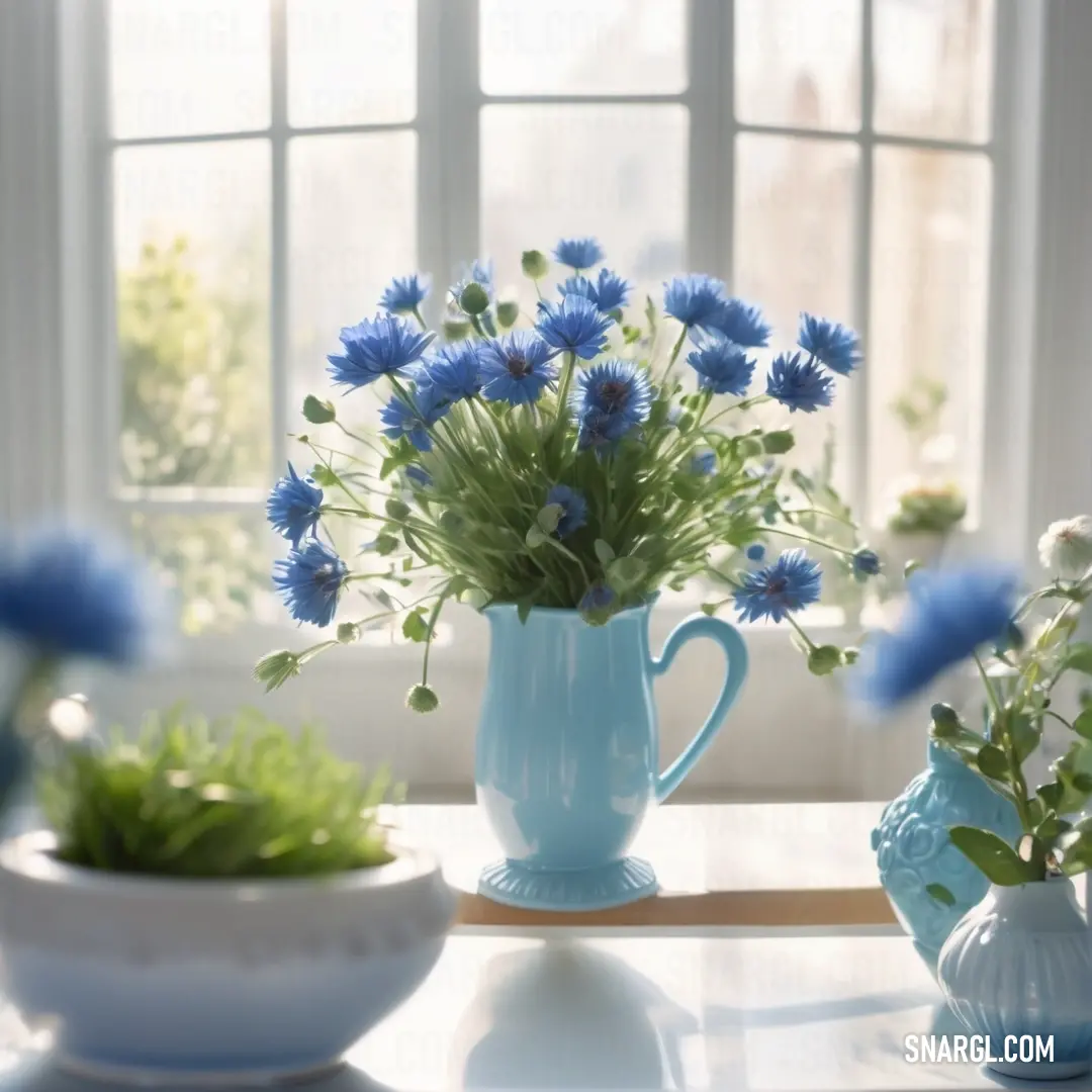 Table with a vase of flowers and a bowl of flowers on it with a window behind it. Color CMYK 67,49,0,0.