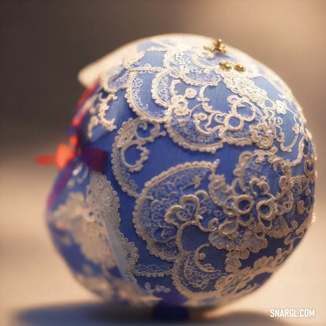 Blue and white ball with a red ribbon on it's side and a red bow on the top. Color CMYK 74,55,0,0.