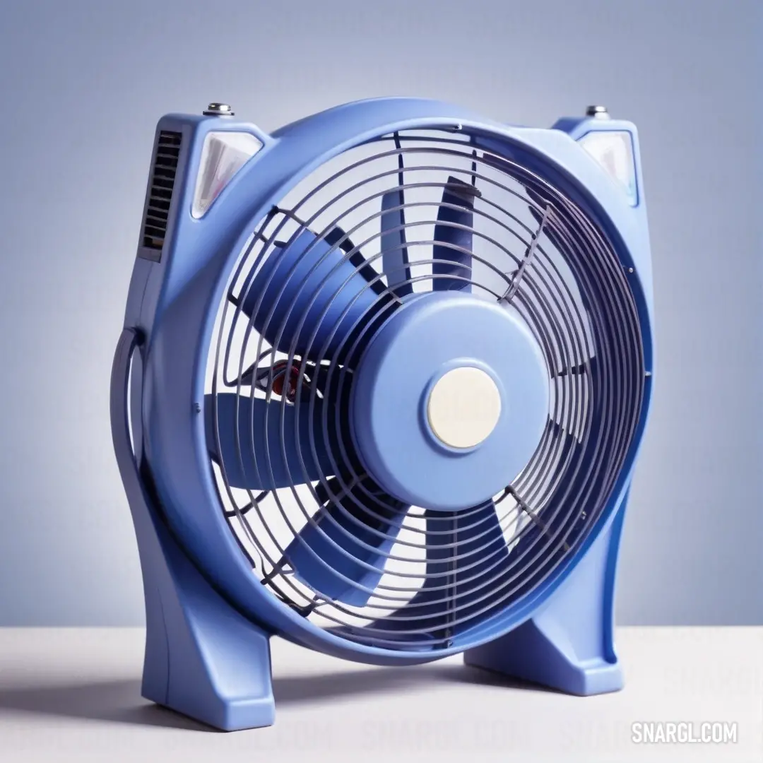Blue fan on top of a table next to a wall mounted clock and a blue wall behind it. Example of #96A9D0 color.