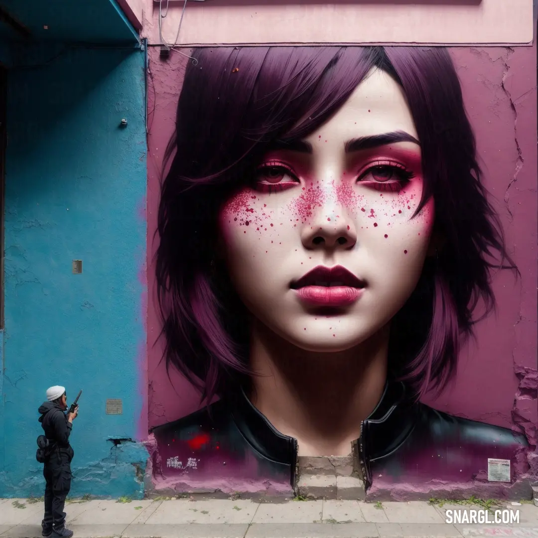 Woman with pink makeup and black hair is painted on a wall with a pink and blue background and a pink