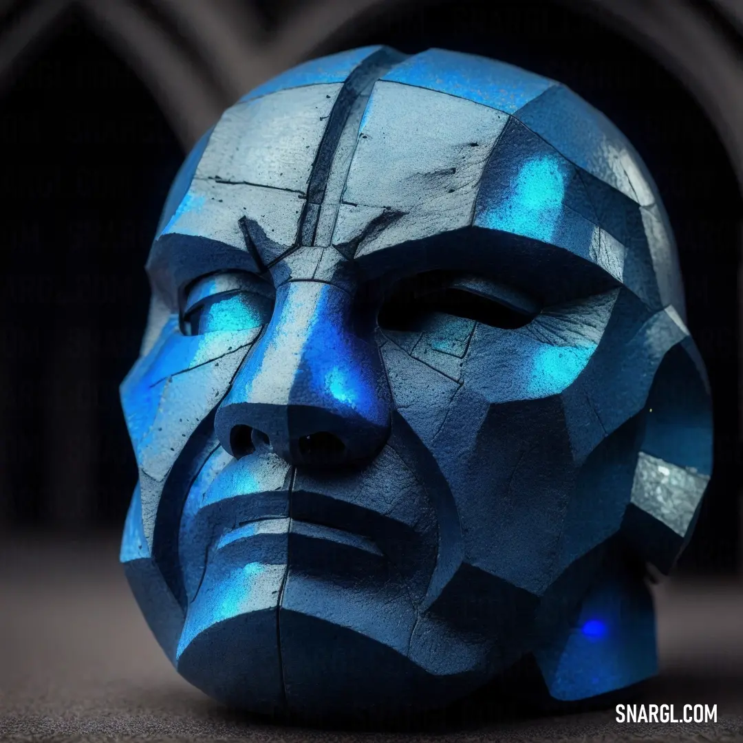 Blue face sculpture on top of a table next to a window with a black curtain behind it. Example of CMYK 82,11,0,0 color.
