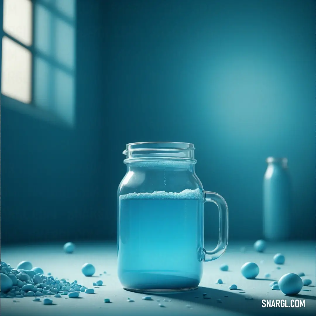 Jar of blue liquid on a table next to a window with drops of water on it and a bottle of water in the background