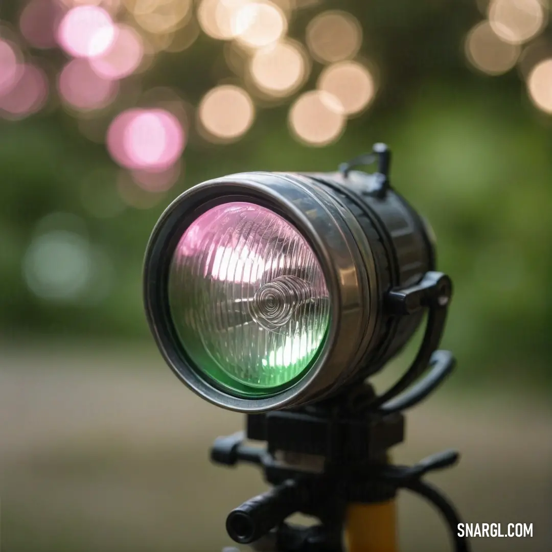 A close-up of a bike light, glowing brightly in the foreground, with a softly blurred background that hints at motion and energy. The subtle play of light and shadow adds depth, focusing attention on the intensity of the light.