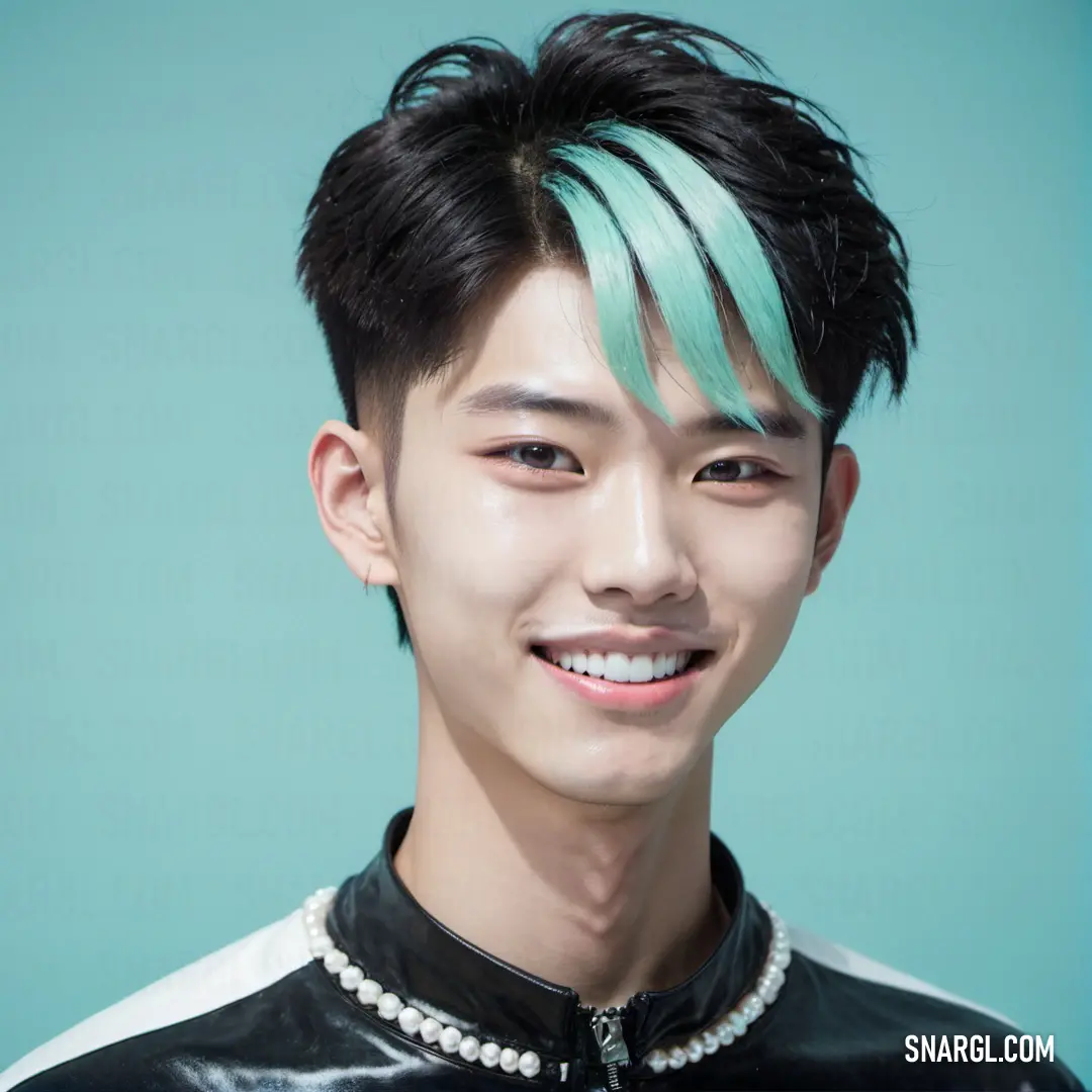 Man with a green hair and a black jacket smiling at the camera with a pearl necklace on his neck. Example of RGB 105,187,188 color.