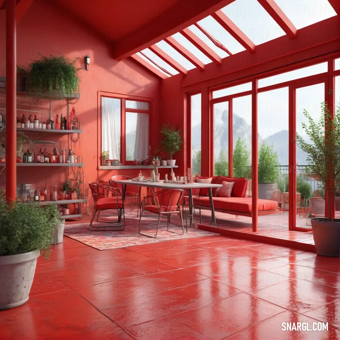 A cozy room featuring a charming table and chairs, with striking red walls and floors complemented by a large window that bathes the space in natural light, enhancing its inviting atmosphere.