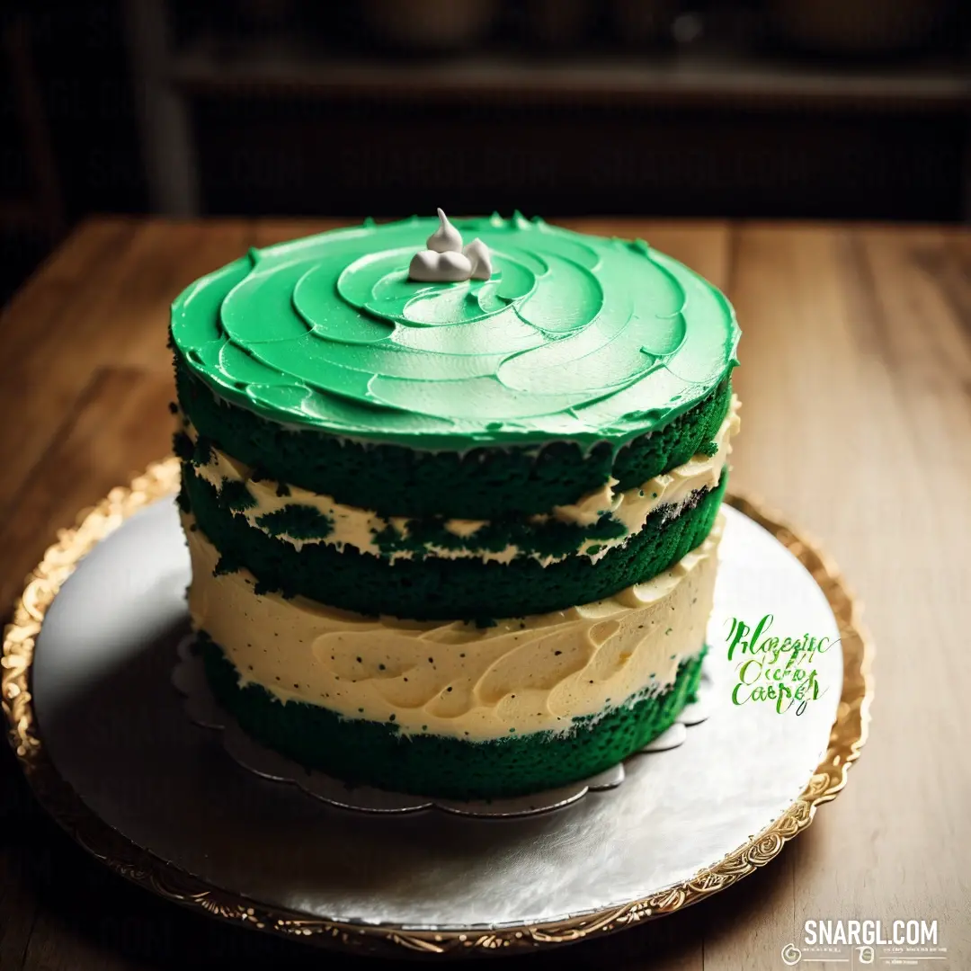 Three layer cake with green frosting on a plate on a table with a wooden table top and a gold rim. Example of PANTONE 2259 color.