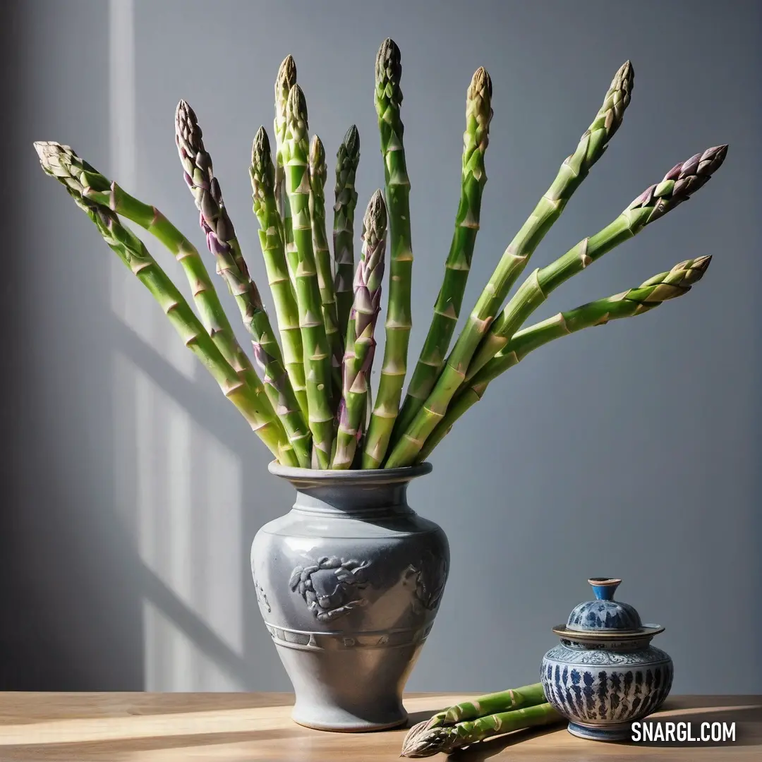 A delightful vase in PANTONE 2284 color showcases a rich assortment of green plants, placed artfully next to a smaller vase, creating a vibrant and cheerful atmosphere in the room.