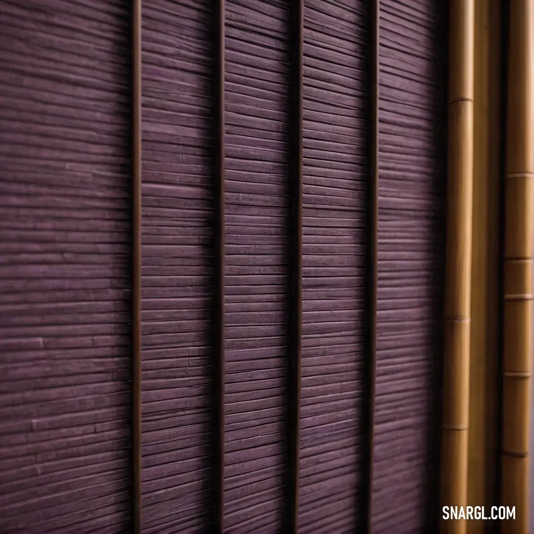 A stunning close-up of bamboo blinds framed by a vibrant purple background, effortlessly blending natural aesthetics with a bold color statement, creating visual harmony.