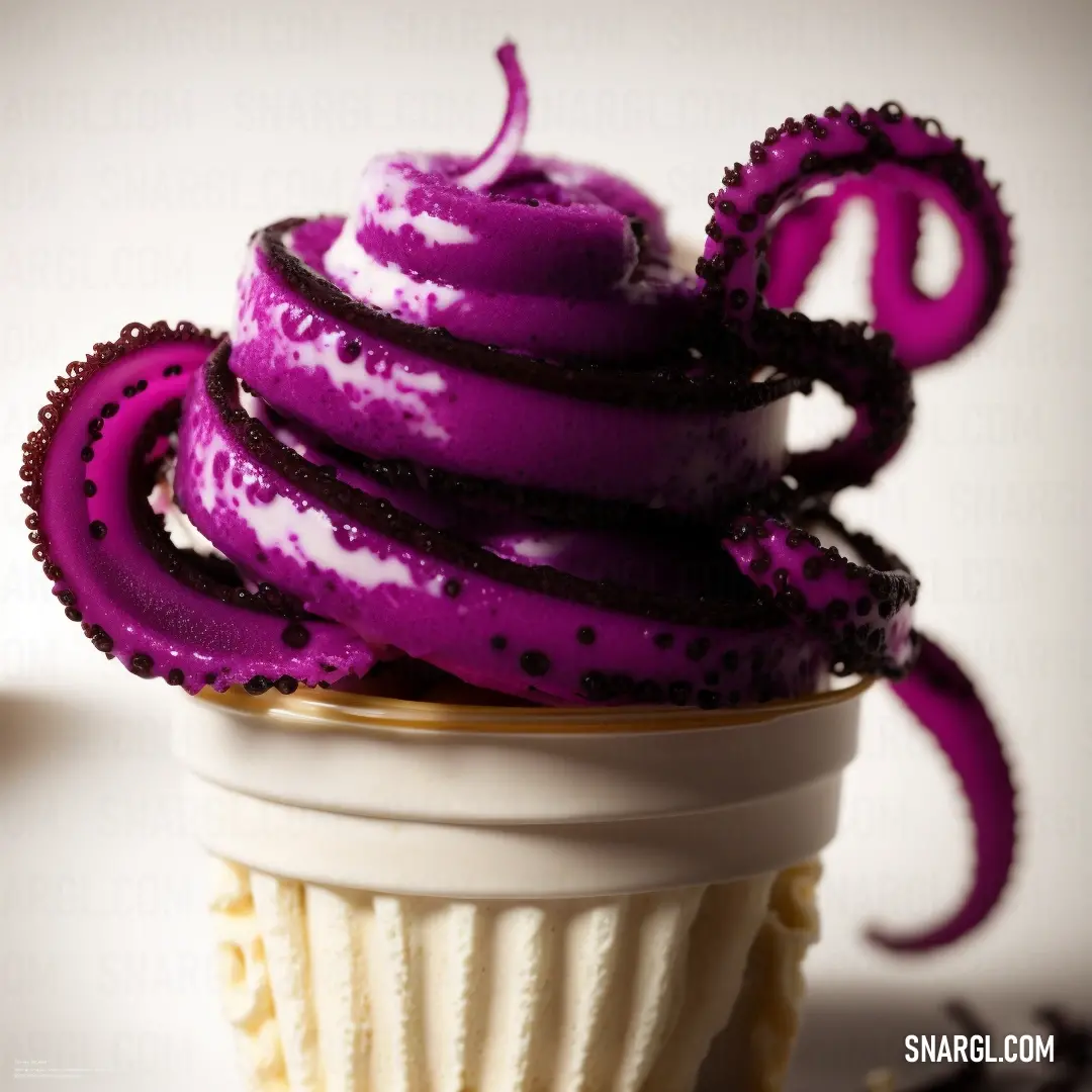 Cupcake with purple icing and a purple octopus on top of it