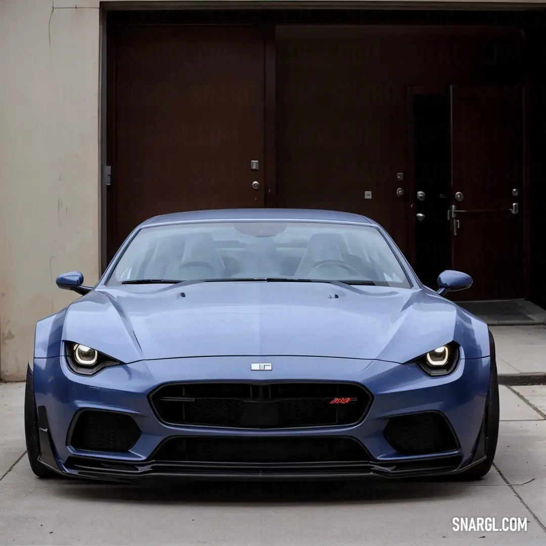 Blue sports car parked in front of a garage door with a brown door behind it and a black door. Example of #53599C color.