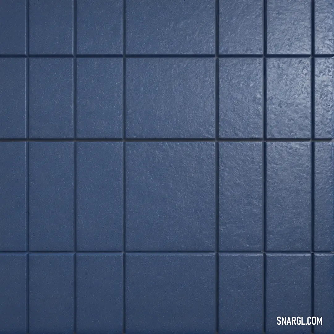 A modern blue-tiled wall featuring a sleek white toilet nestled in the corner, with a harmonious blue tiled floor that completes the stylish look of the bathroom.