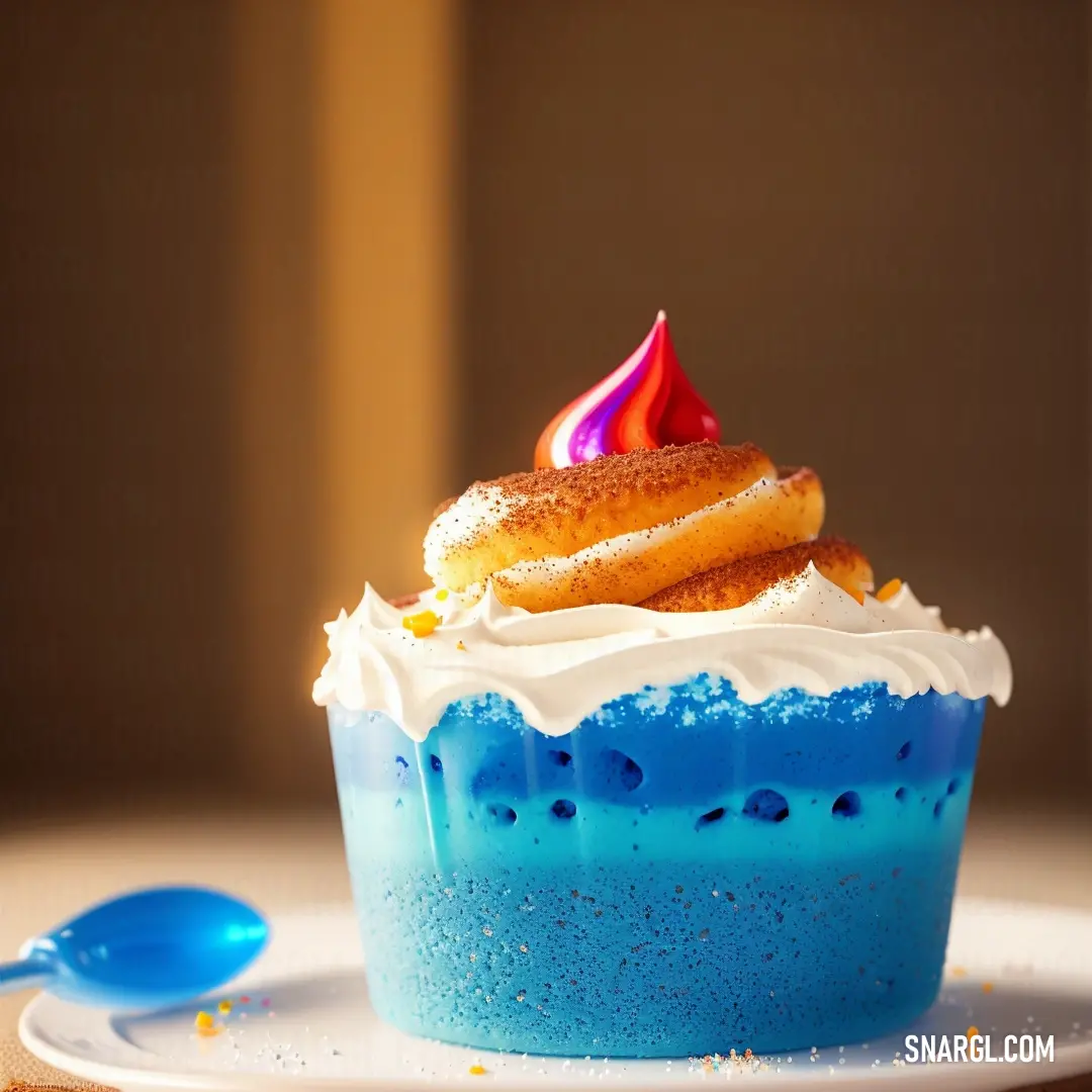 Blue dessert with a white frosting and a pink candle on top of it on a plate with a spoon. Color CMYK 86,31,11,5.