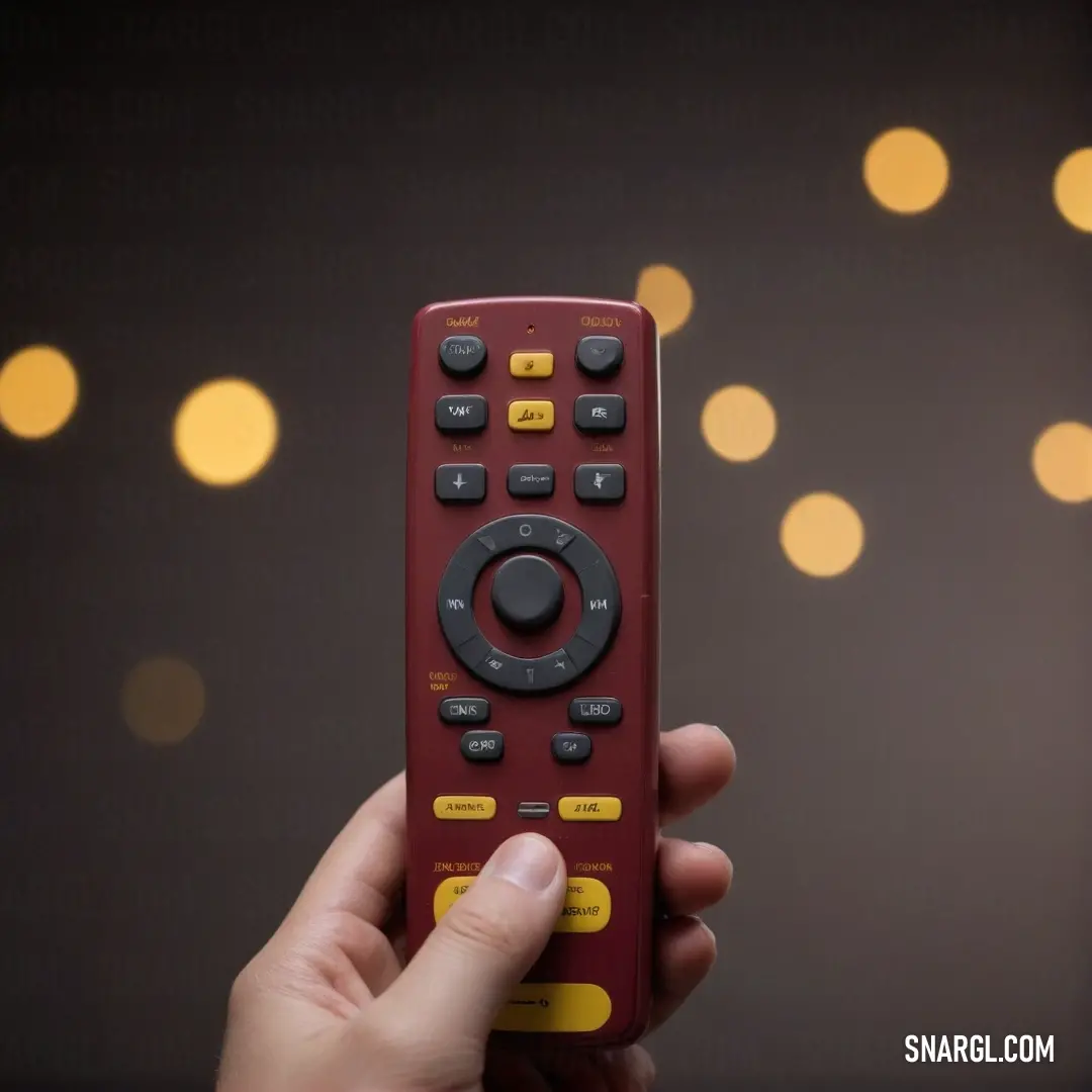 A hand gracefully holds a vibrant red remote control in front of a backdrop of twinkling Christmas lights. The festive atmosphere is enhanced by the enchanting color scheme of PANTONE 242, radiating warmth and cheer.