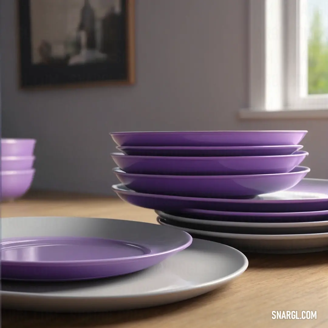 A stack of purple and white plates rests on a table next to a window with a view of a building. The rich color #81255C of the plates adds elegance to the serene and minimalistic dining scene.