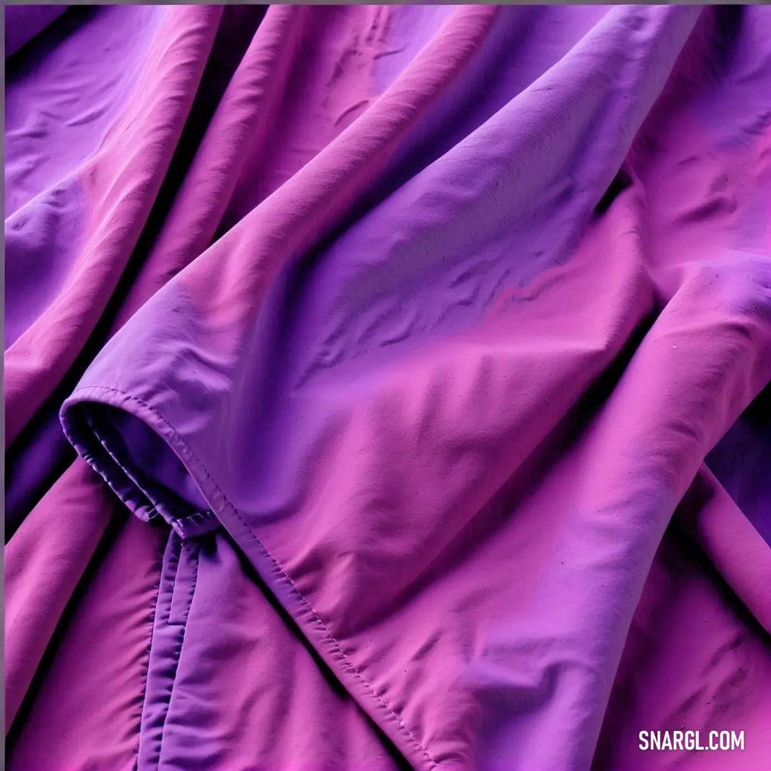 Purple jacket with a black zipper on it and a black button on the bottom of the jacket