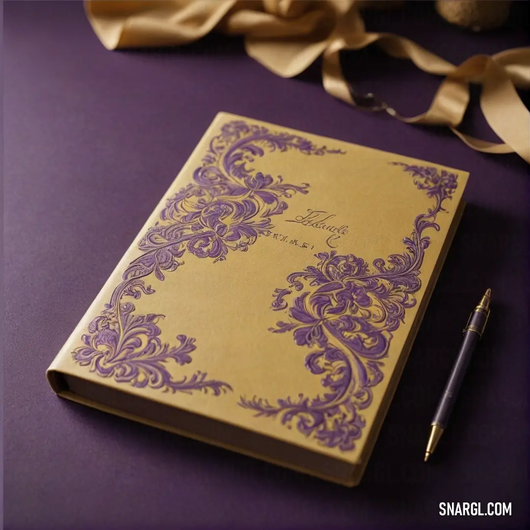 An elegantly understated wedding guest book in rich purple hues lies alongside a sleek pen, accented with a delicate ribbon, evoking a sense of love and celebration in its simple charm.