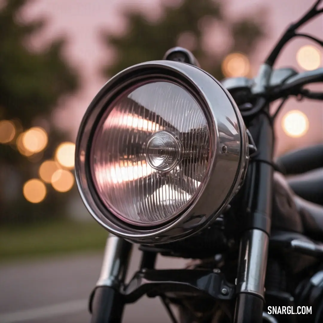 A close-up view of a motorcycle headlight illuminates the surroundings, creating a mesmerizing glow that highlights the intricate details and craftsmanship of the motorcycle. The vibrant PANTONE 2622 color shines brilliantly, making this scene a thrilling