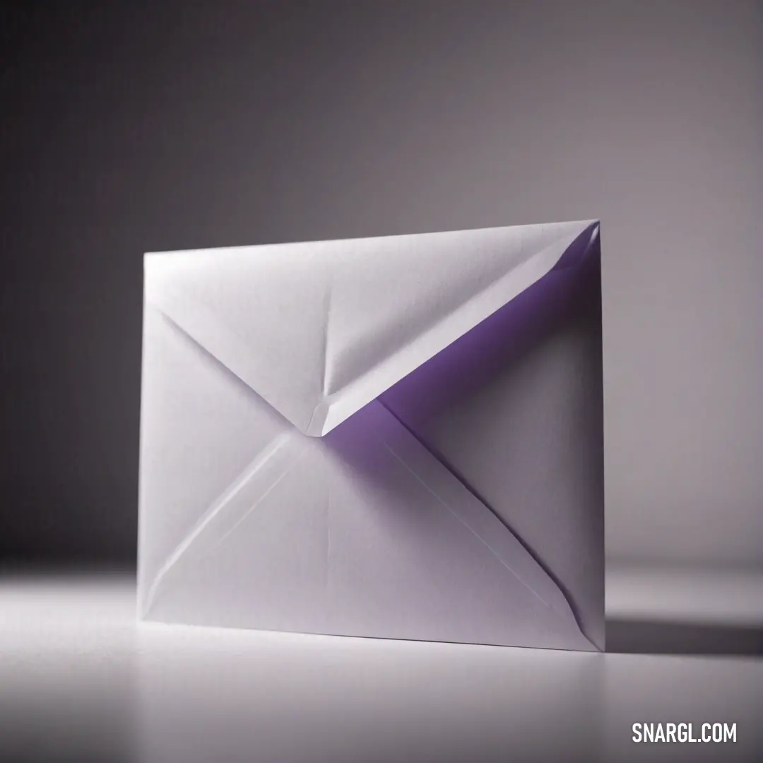 An elegant envelope rests on a gray tabletop, gracefully revealing a piece of vibrant purple paper inside. This combination of elements engages the senses, hinting at the secrets and messages it may hold.