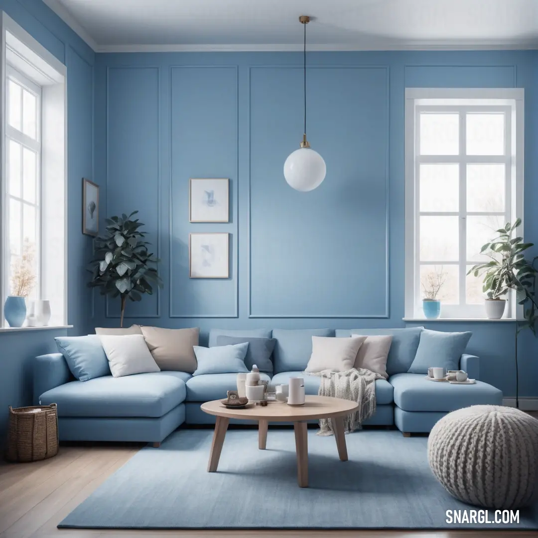 Living room with blue walls and a blue couch and coffee table in the middle of the room