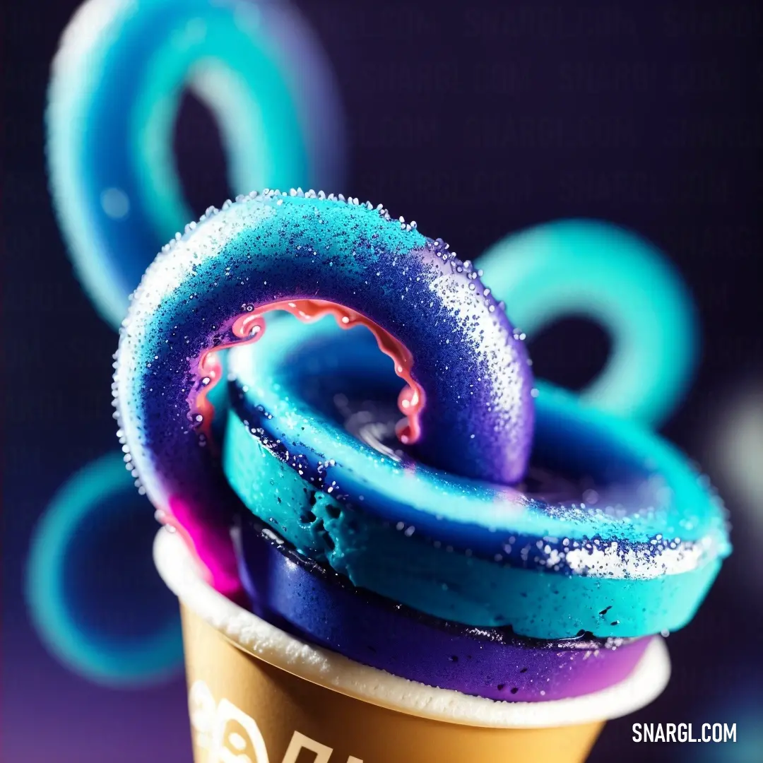 Cup of coffee with a blue and purple swirl on top of it and a cup of coffee with a blue and purple swirl on top