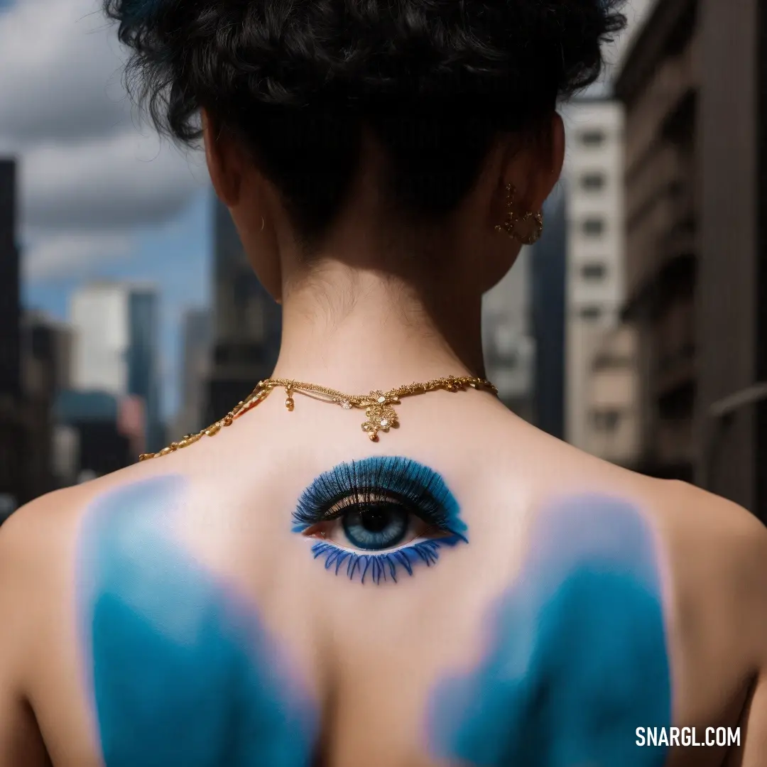 Woman with blue makeup and a blue eyeball on her back neck and chest. Color PANTONE 285.