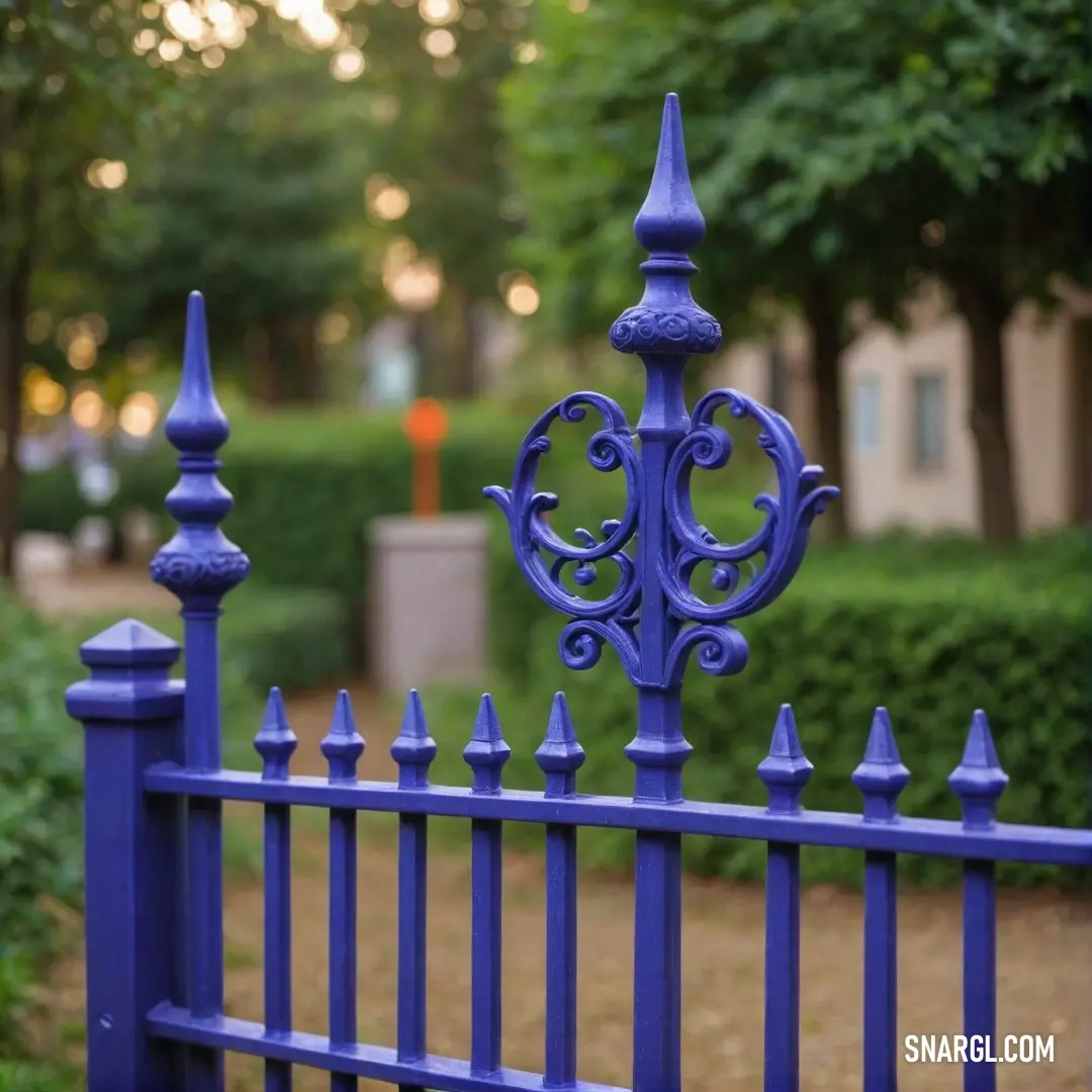 A picturesque scene featuring a sturdy blue fence standing tall against the backdrop of a beautifully lush tree, creating a serene connection between nature and human craftsmanship, infused with tranquility and rustic charm.