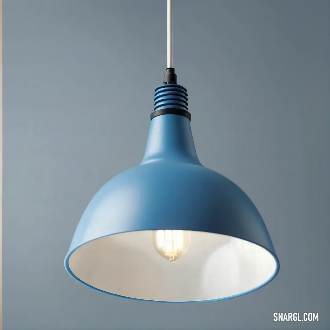 A beautiful blue light pendant, featuring a soft white bulb, dangles from a ceiling. Its cool tone contrasts gracefully with the warm glow, creating an inviting atmosphere that elevates the style of the room.