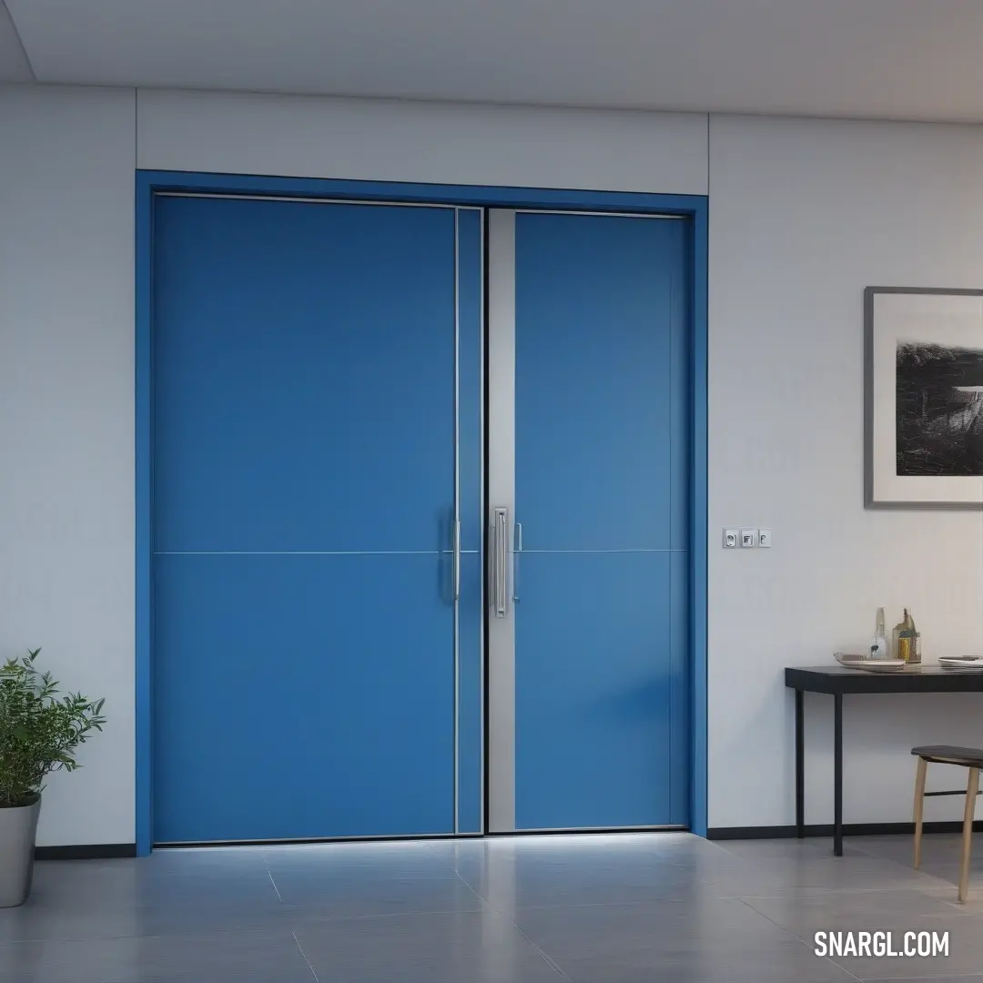 A room with a vibrant blue door and a table featuring a lush potted plant, all framed by a picture on the wall. The color of the door adds character and charm to the otherwise serene, minimalist interior.