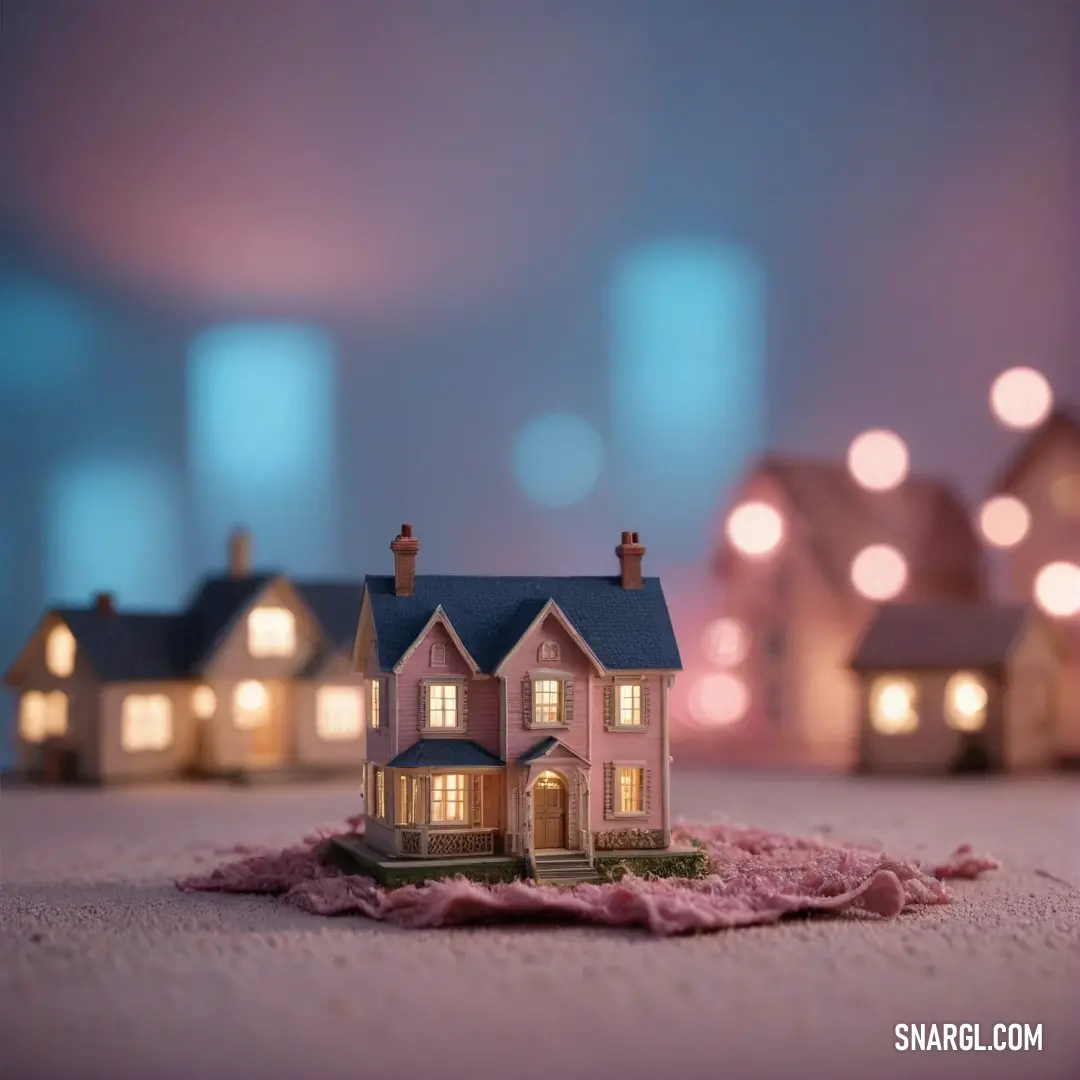 A quaint small house rests delicately on a pink blanket, beautifully framed by rows of illuminated neighboring houses. The charming setup vividly embodies the splendid hue of PANTONE 297, creating a serene and welcoming vignette under the night sky.