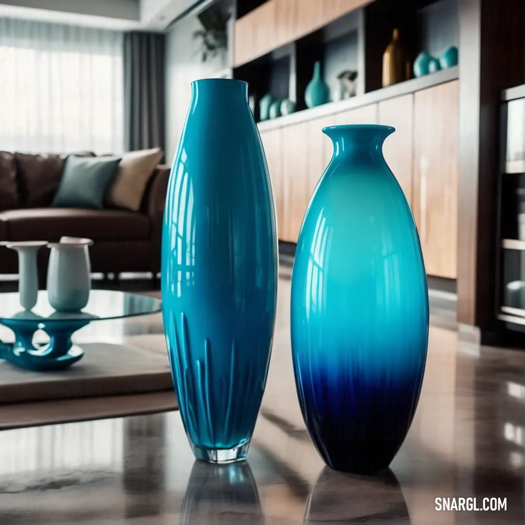 Table with two blue vases on it and a couch in the background. Example of CMYK 88,0,11,0 color.